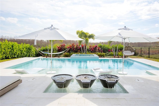 view of pool featuring a patio and an in ground hot tub