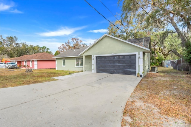 single story home with a garage and a front yard