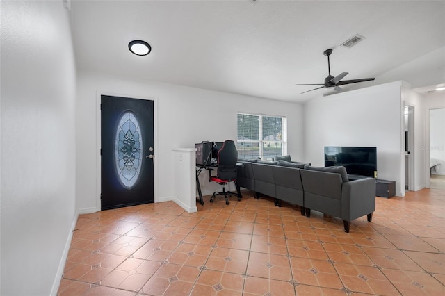 foyer with ceiling fan, lofted ceiling, and light tile patterned floors