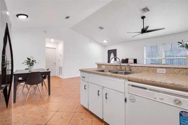 kitchen featuring lofted ceiling, sink, dishwasher, white cabinetry, and light tile patterned flooring