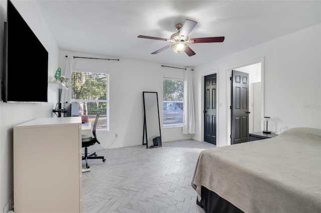 bedroom with ceiling fan and light parquet flooring