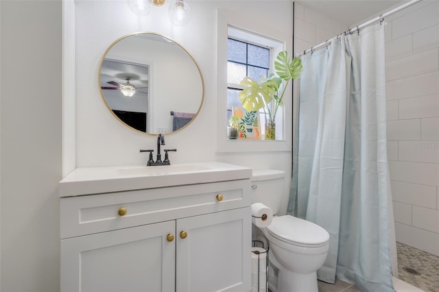 bathroom featuring a shower with curtain, vanity, and toilet