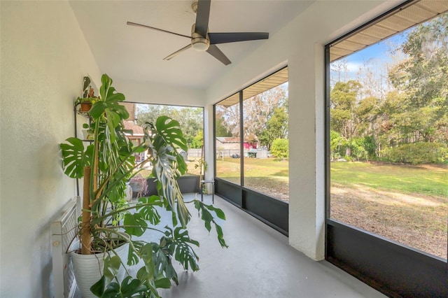 sunroom / solarium with ceiling fan and a healthy amount of sunlight