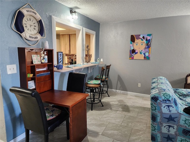 dining space with a textured ceiling