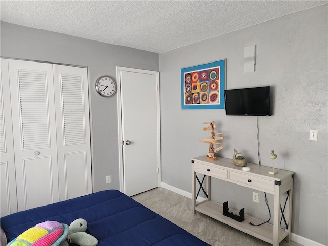 bedroom with a closet and a textured ceiling