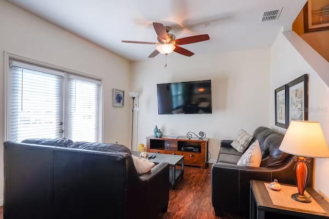 living room featuring ceiling fan and dark hardwood / wood-style flooring