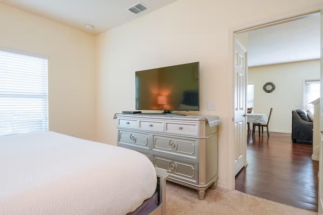 bedroom with dark hardwood / wood-style flooring