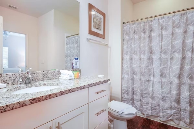 bathroom with vanity, toilet, a shower with shower curtain, and wood-type flooring