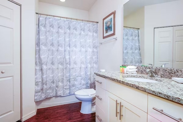 full bathroom featuring hardwood / wood-style flooring, vanity, toilet, and shower / bath combo with shower curtain