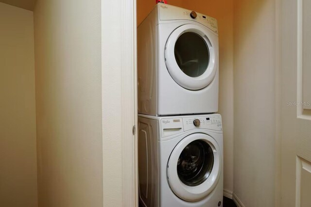 washroom featuring stacked washer and dryer