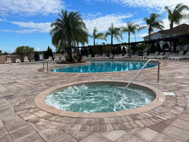 view of swimming pool featuring a patio and a community hot tub