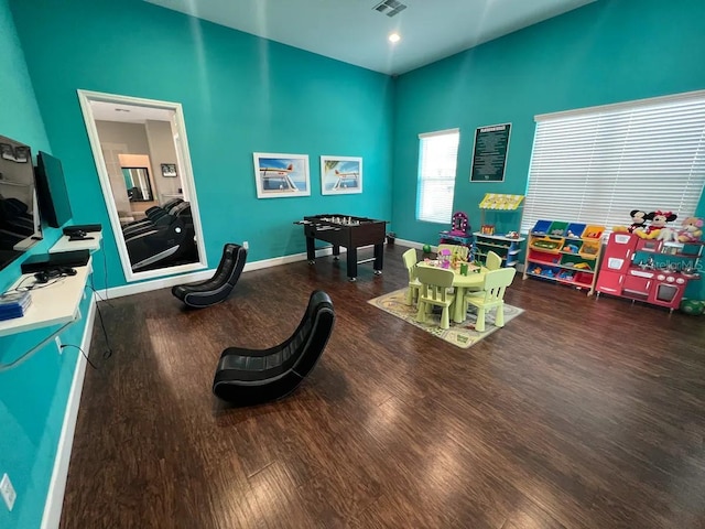 game room with dark wood-type flooring