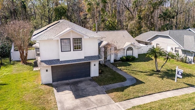 view of front facade with a garage and a front lawn