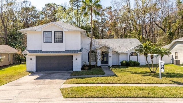 tri-level home with a garage, central AC, and a front yard