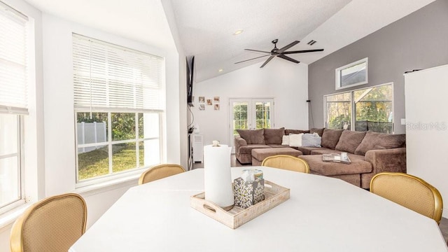 dining space with lofted ceiling, ceiling fan, and french doors