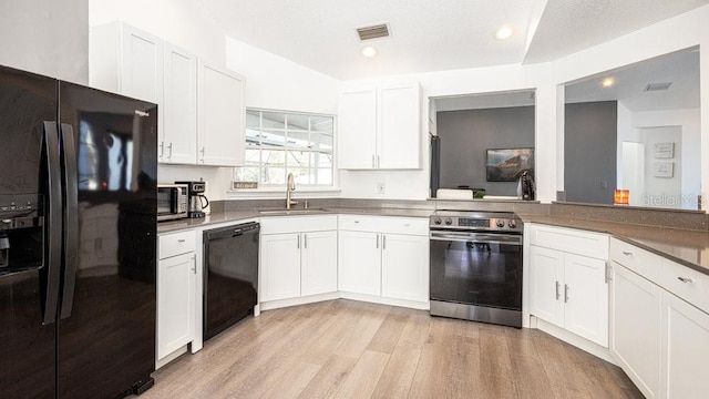 kitchen featuring white cabinetry, light hardwood / wood-style floors, sink, and black appliances