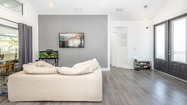 living room featuring french doors, lofted ceiling, and hardwood / wood-style floors