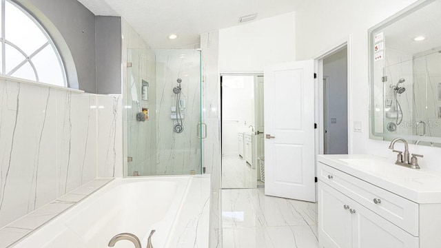 bathroom with vanity and independent shower and bath