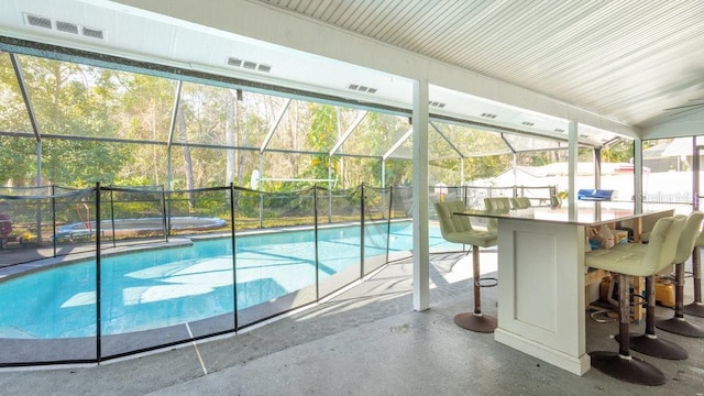 view of pool featuring a lanai, a patio, and exterior bar