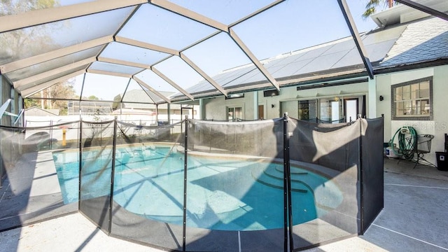 view of swimming pool featuring a lanai and a patio area