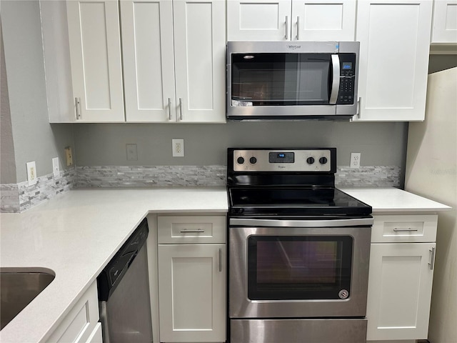 kitchen with stainless steel appliances and white cabinets