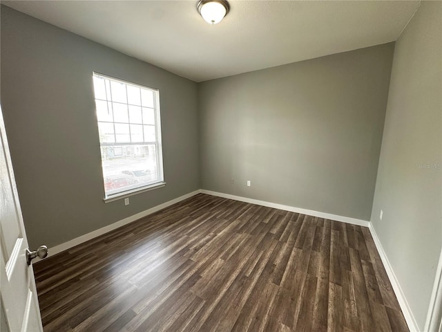 empty room featuring dark hardwood / wood-style flooring