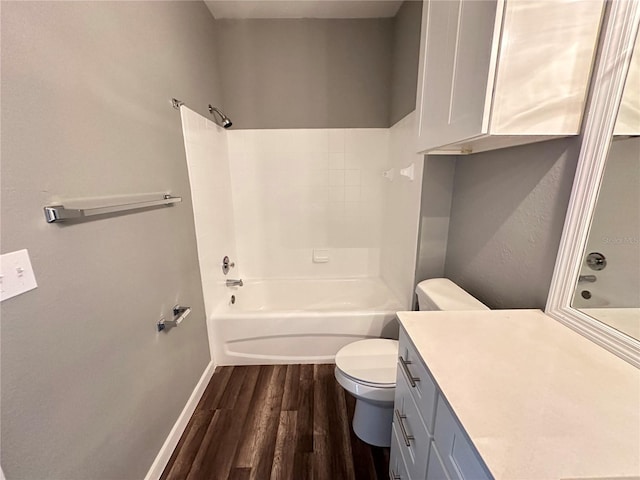 full bathroom featuring vanity, hardwood / wood-style flooring, toilet, and washtub / shower combination