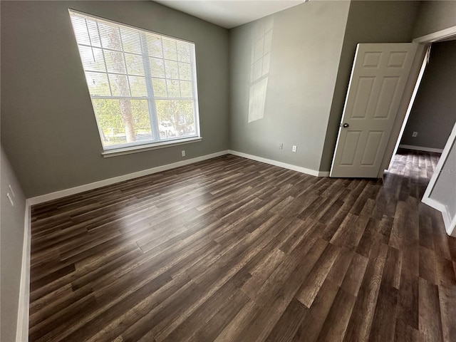 spare room with dark hardwood / wood-style floors