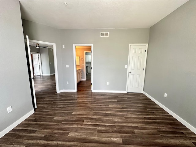 unfurnished bedroom featuring dark wood-type flooring