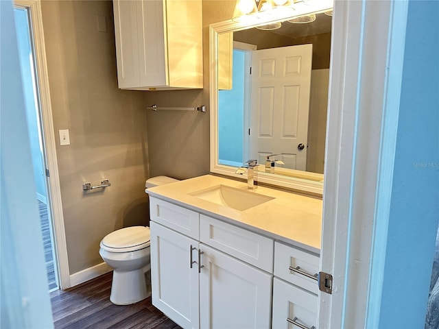 bathroom featuring hardwood / wood-style flooring, vanity, and toilet