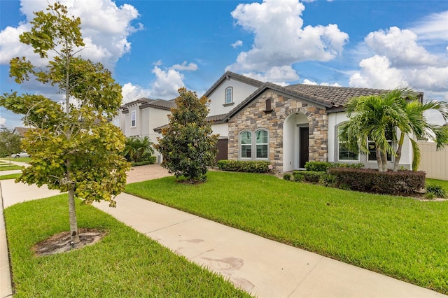 mediterranean / spanish house with a front yard