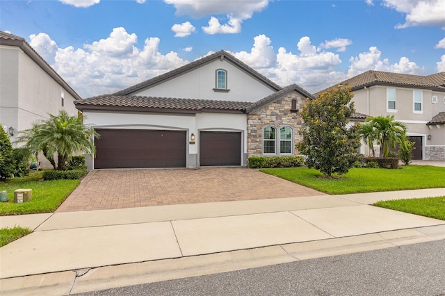 mediterranean / spanish-style house featuring a garage and a front lawn