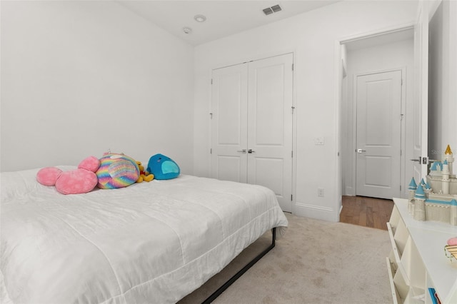 carpeted bedroom with a closet