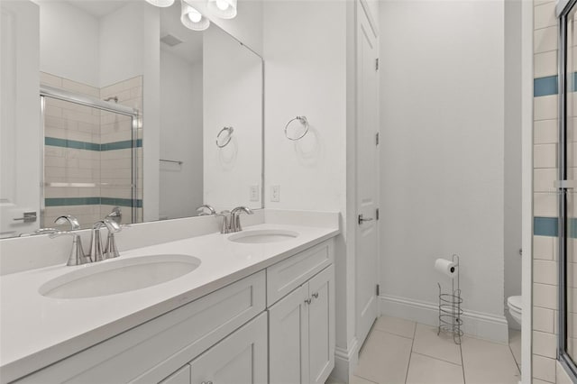 bathroom with vanity, an enclosed shower, tile patterned floors, and toilet