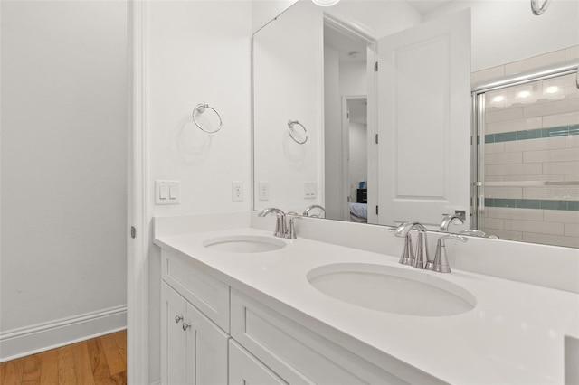 bathroom featuring vanity, a shower with shower door, and hardwood / wood-style floors