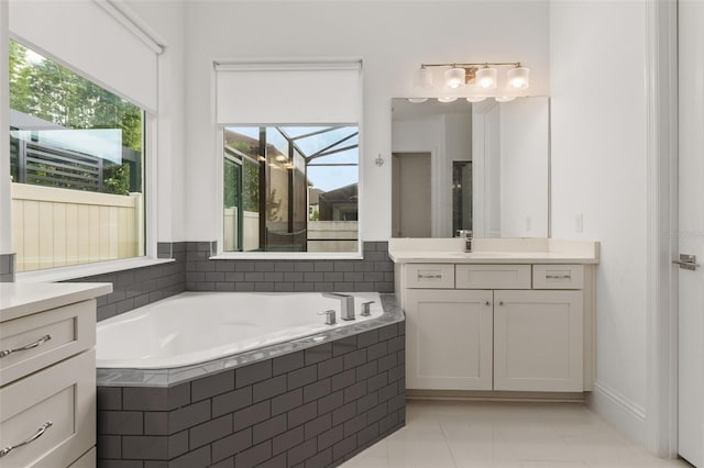 bathroom featuring vanity and tiled tub