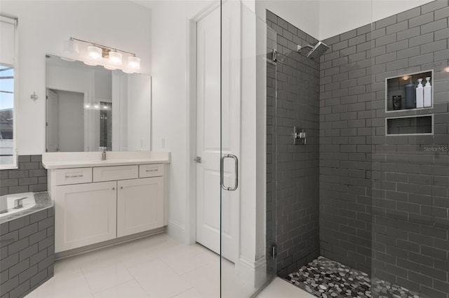 bathroom with vanity, tile patterned floors, and a shower with shower door