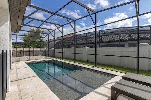 view of swimming pool with a patio and a lanai