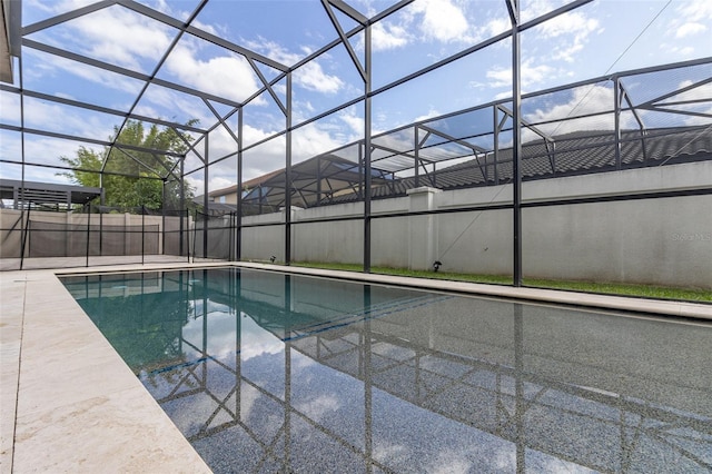 view of pool with glass enclosure