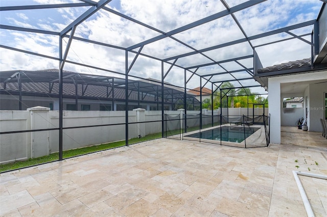 view of pool with a patio area and glass enclosure