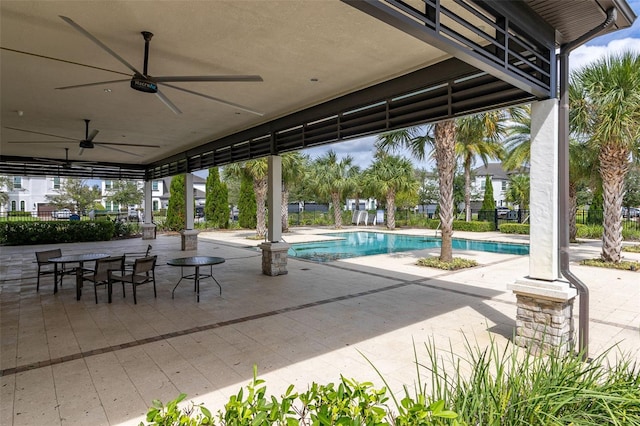 view of pool with ceiling fan and a patio