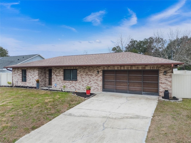 ranch-style house featuring a garage and a front yard