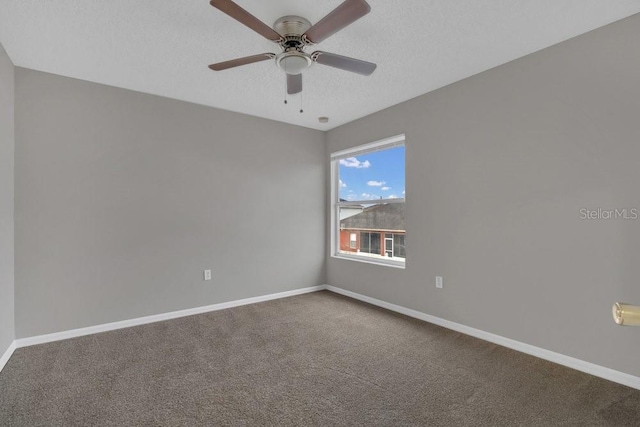 carpeted empty room with ceiling fan and a textured ceiling