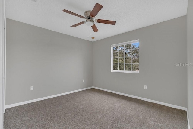 empty room featuring ceiling fan, carpet, and a textured ceiling