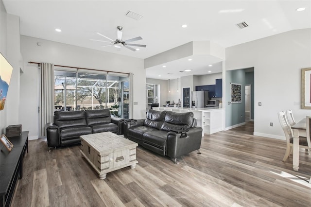 living room featuring hardwood / wood-style floors and ceiling fan