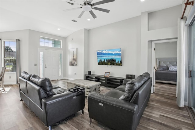 living room featuring wood-type flooring, high vaulted ceiling, and ceiling fan