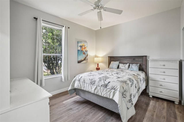 bedroom with dark wood-type flooring and ceiling fan