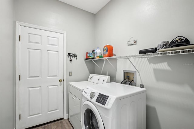 laundry room featuring dark hardwood / wood-style flooring and washer and dryer