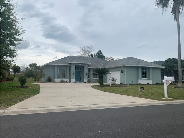 ranch-style home with a garage and a front lawn