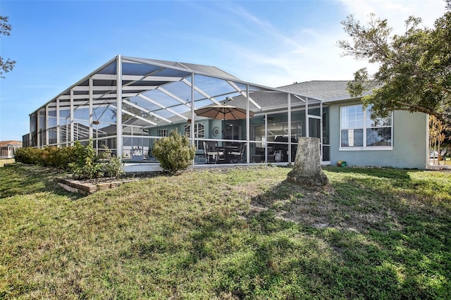 back of property with a lanai and a lawn